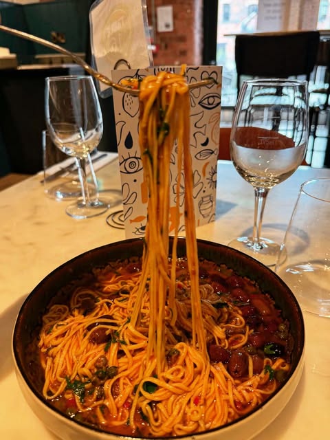 A fork lifting freshly made pasta at Vé•ra